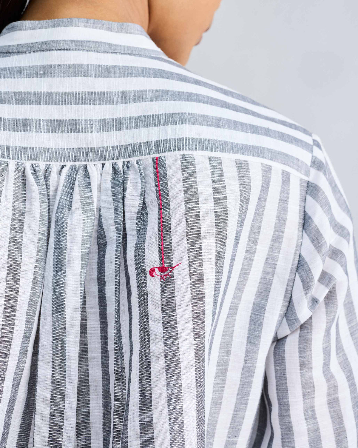 Close-up of the Mandarin Collar shirt's back yoke showing a small red embroidered motif.
