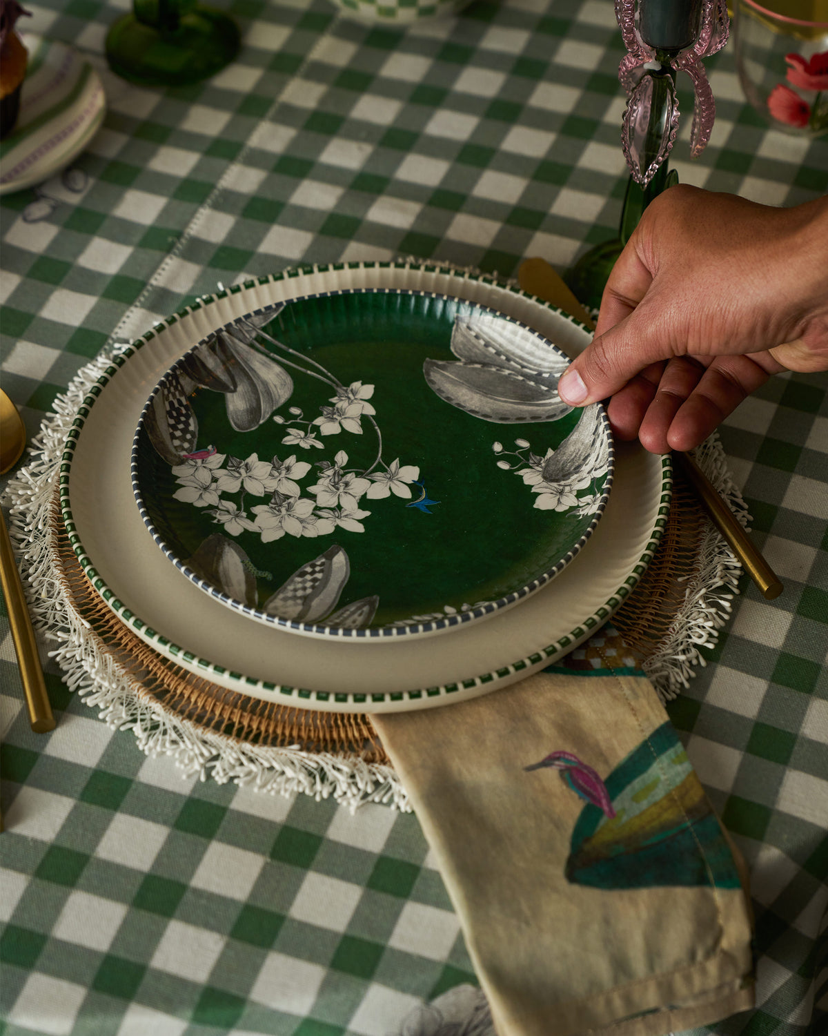 Person holding Reesha Quarter Plate - Green in a place setting.