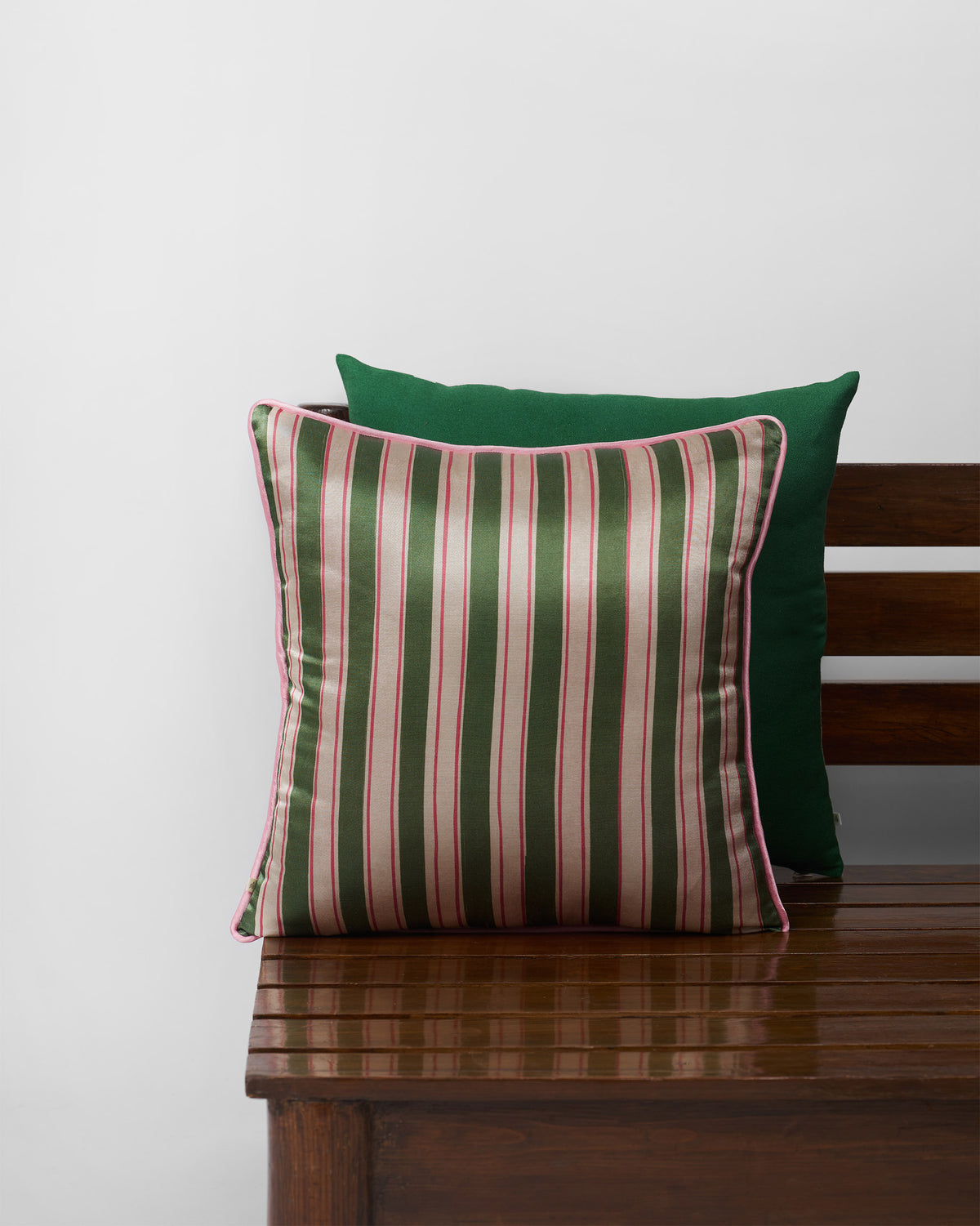 Buransh Cushion Cover with green and pink stripes and pink piping.