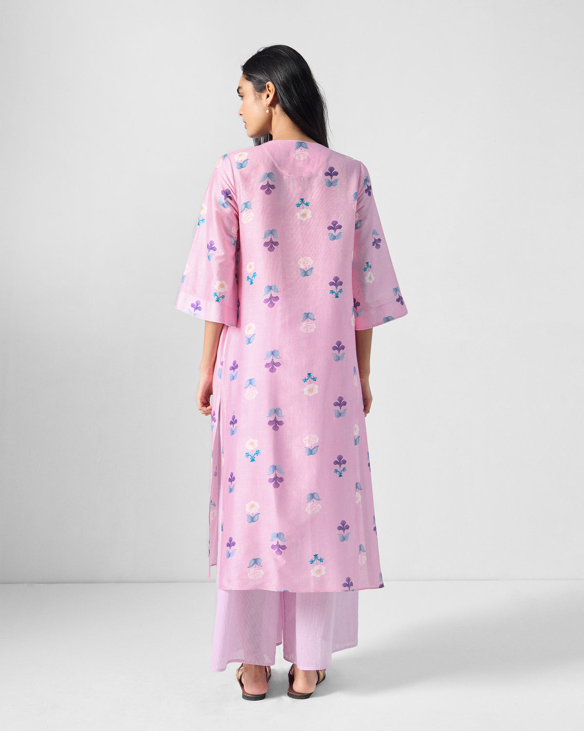 Back of a pink floral Hera Kurta Set with side slits.