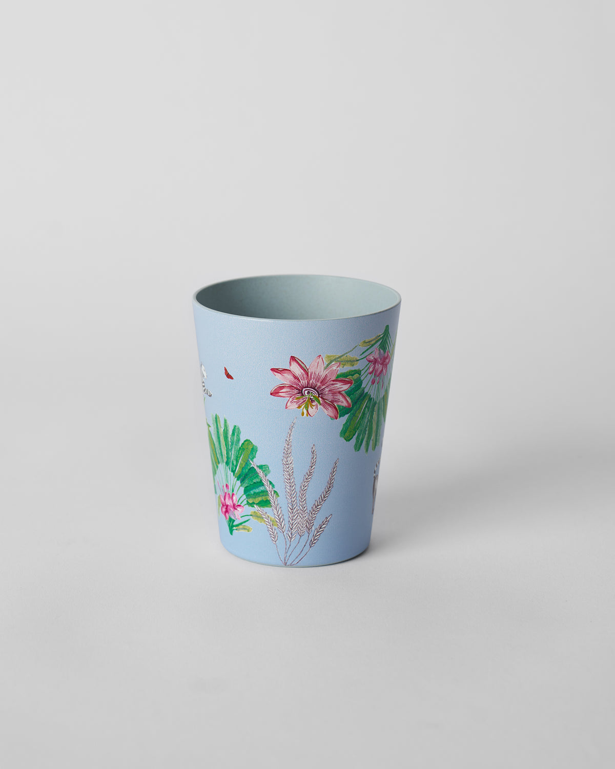 Dusty blue Toucan bamboo tumbler with a pink tropical flower and green fan leaves.