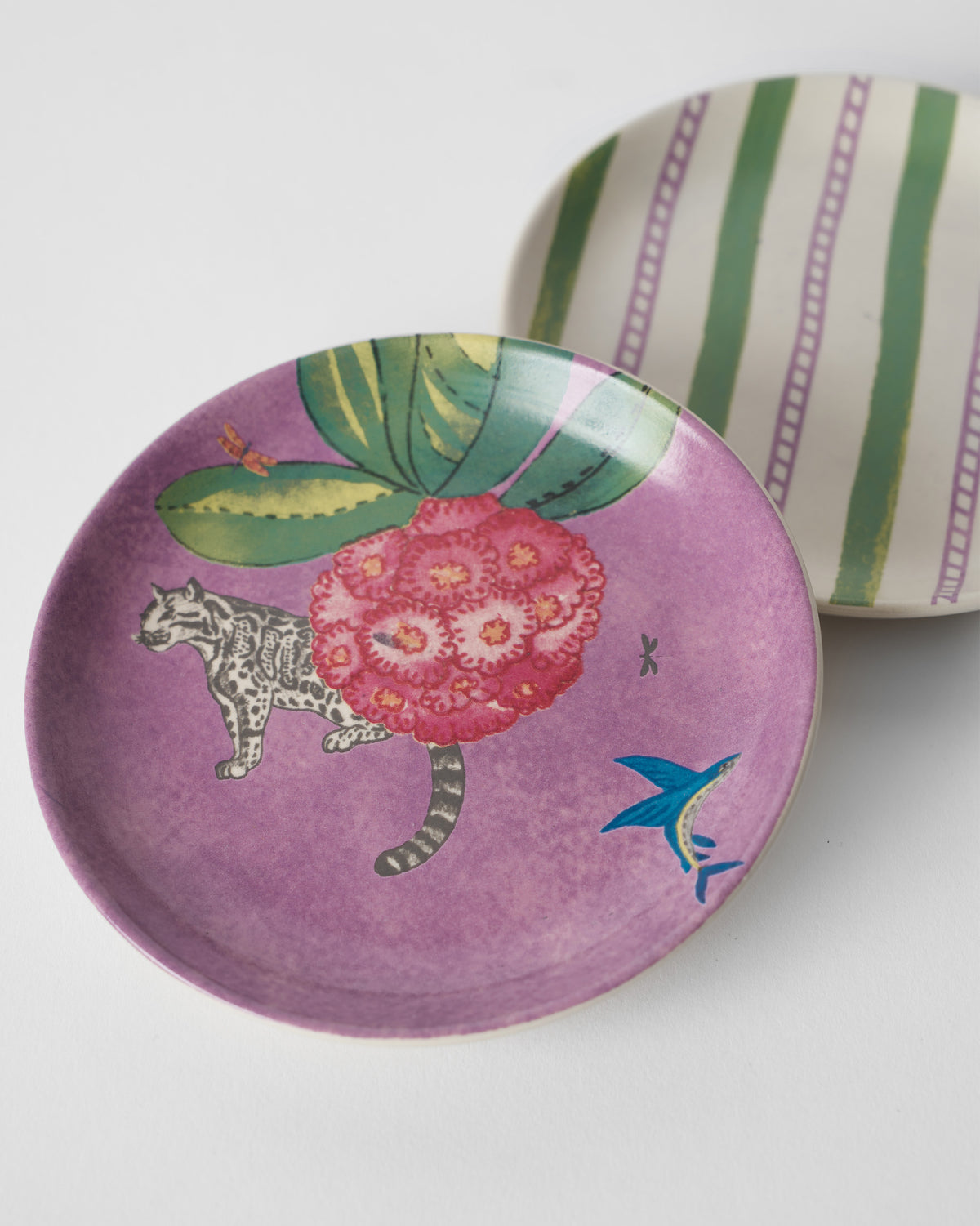 Buransh Tea Plates pairing a purple bloom plate with green stripes.
