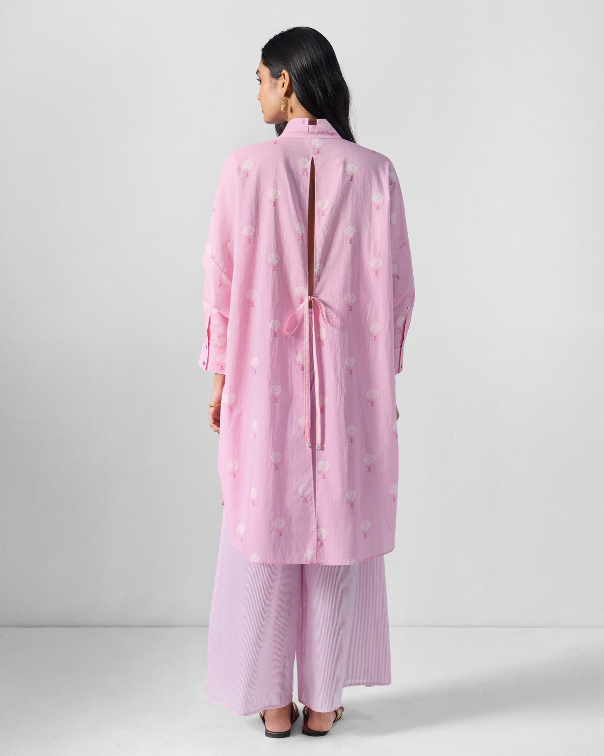 Back of a pink floral tunic with a slit back and tie-up detail.
