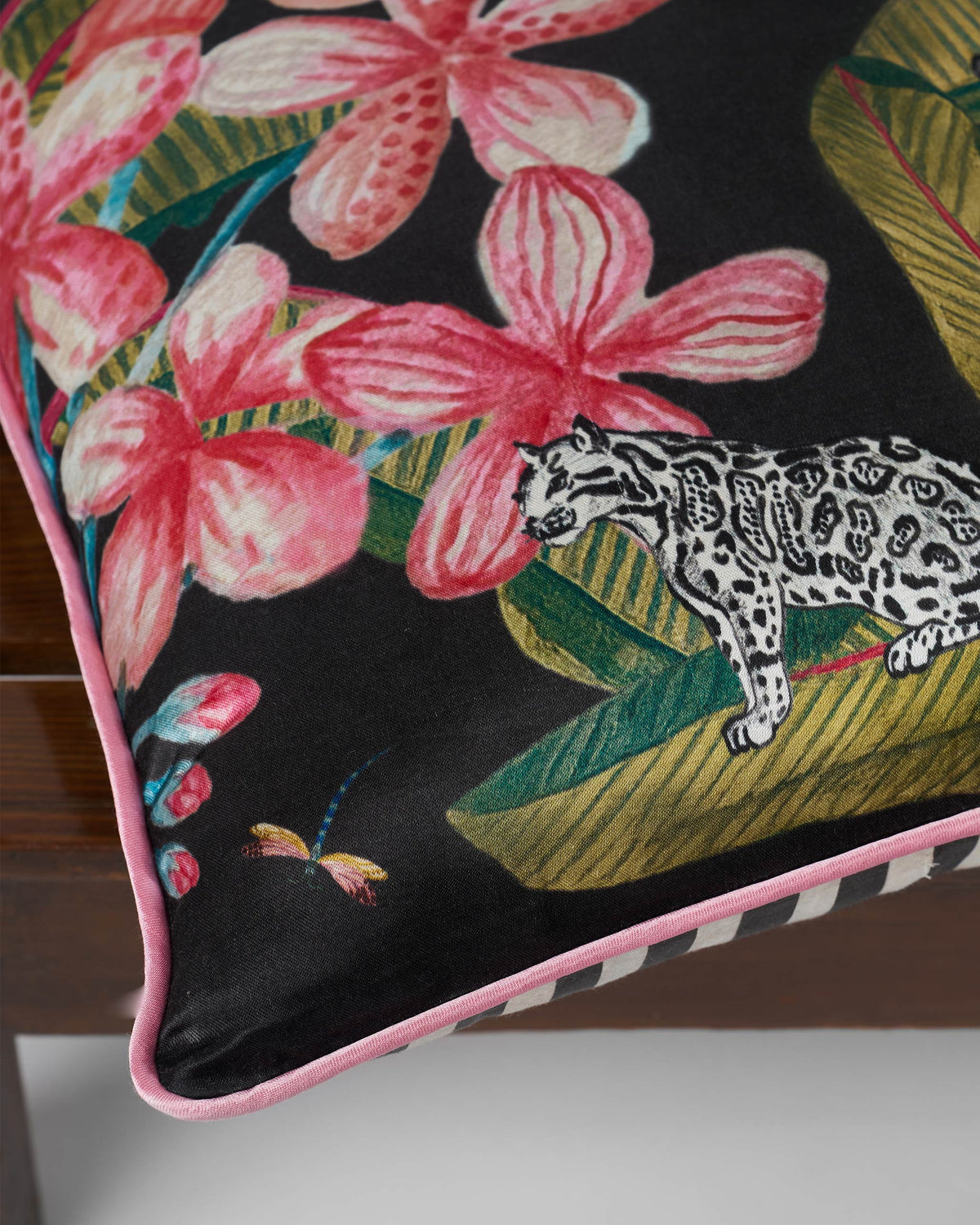 Close-up of the Malti cushion cover showing pink flowers and a leopard.
