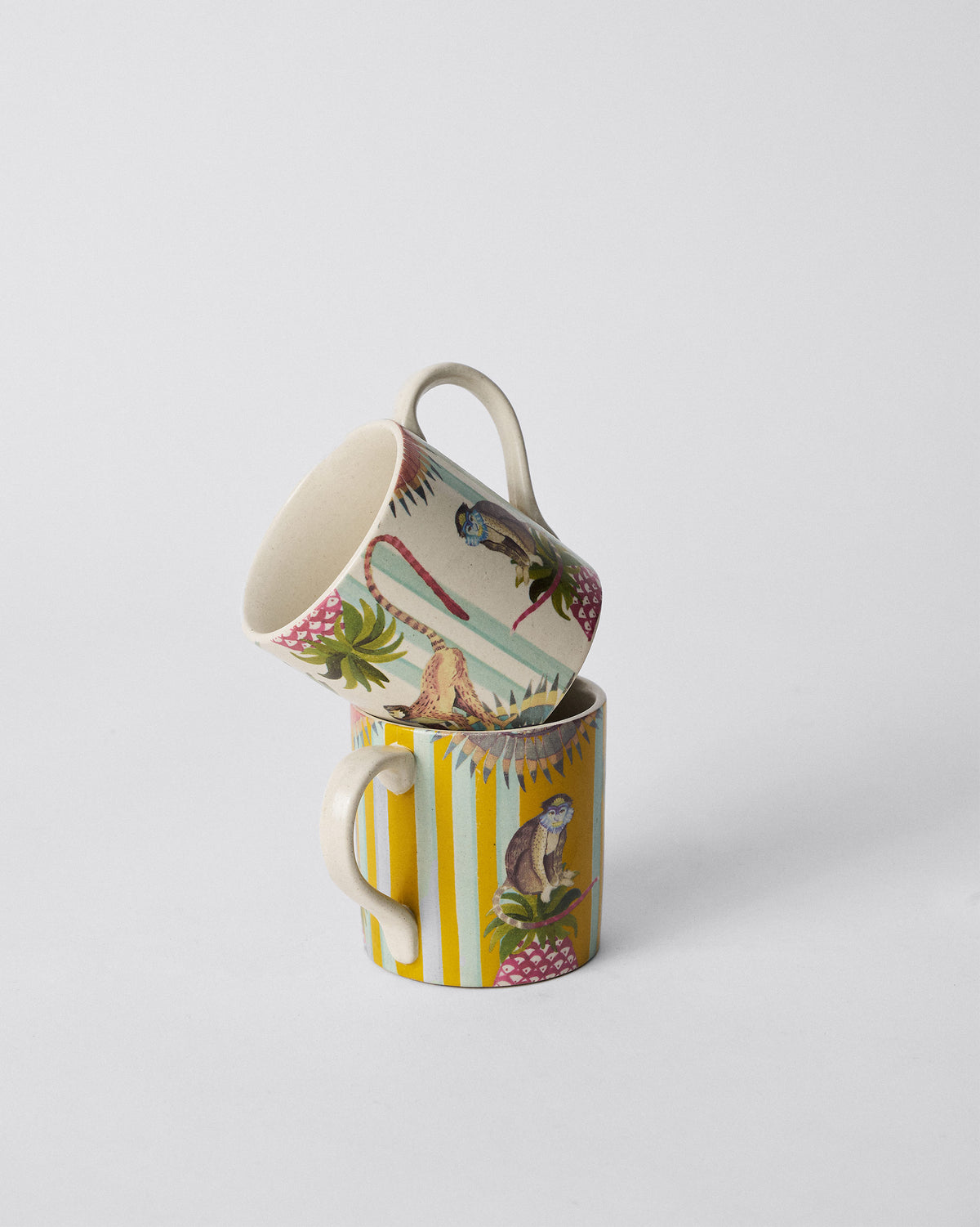 Ivory Mahi Mug stacked on a yellow one from the Mahi Mug Set.
