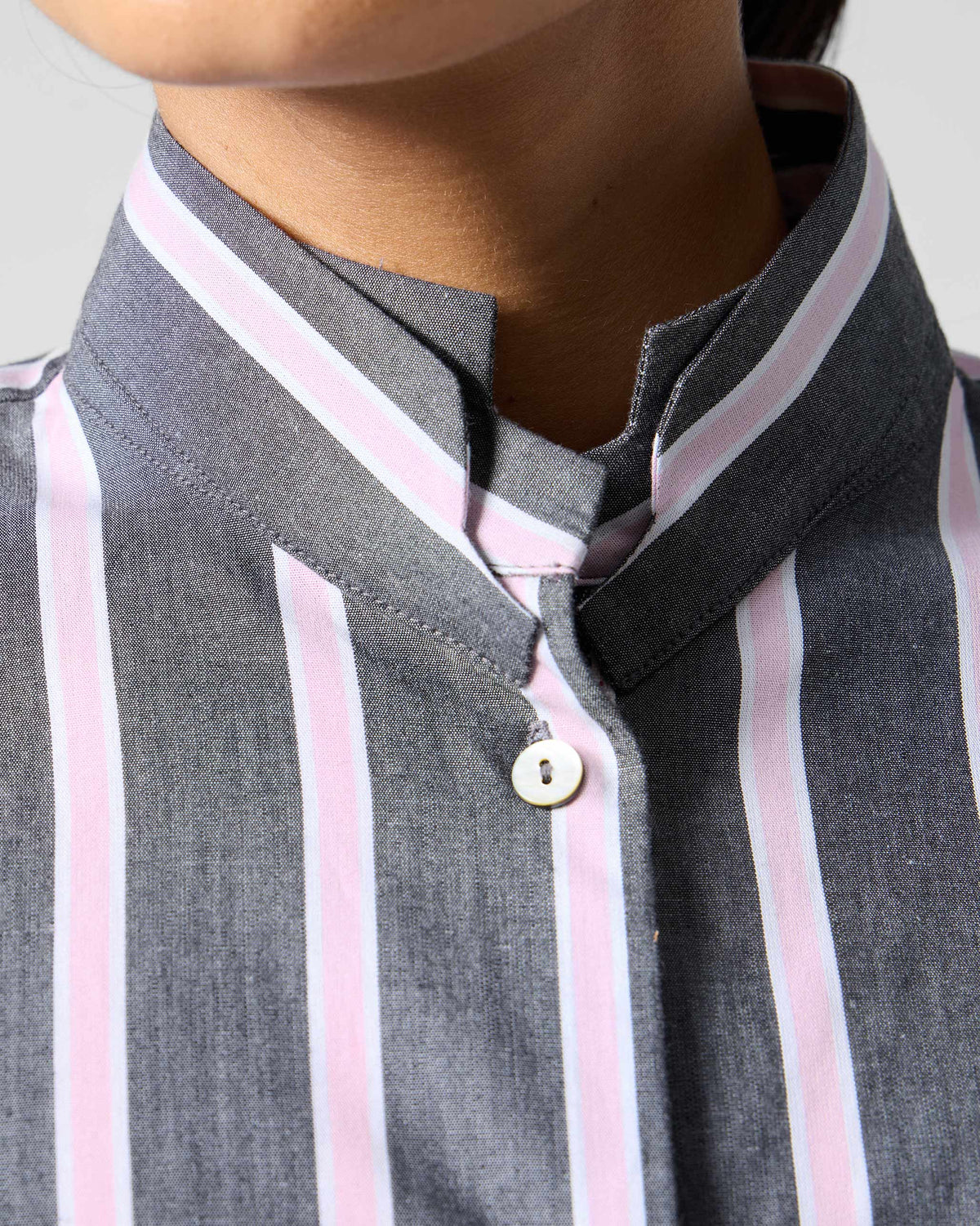 Close-up of a charcoal and pink striped Trench shirt showing the mandarin collar.