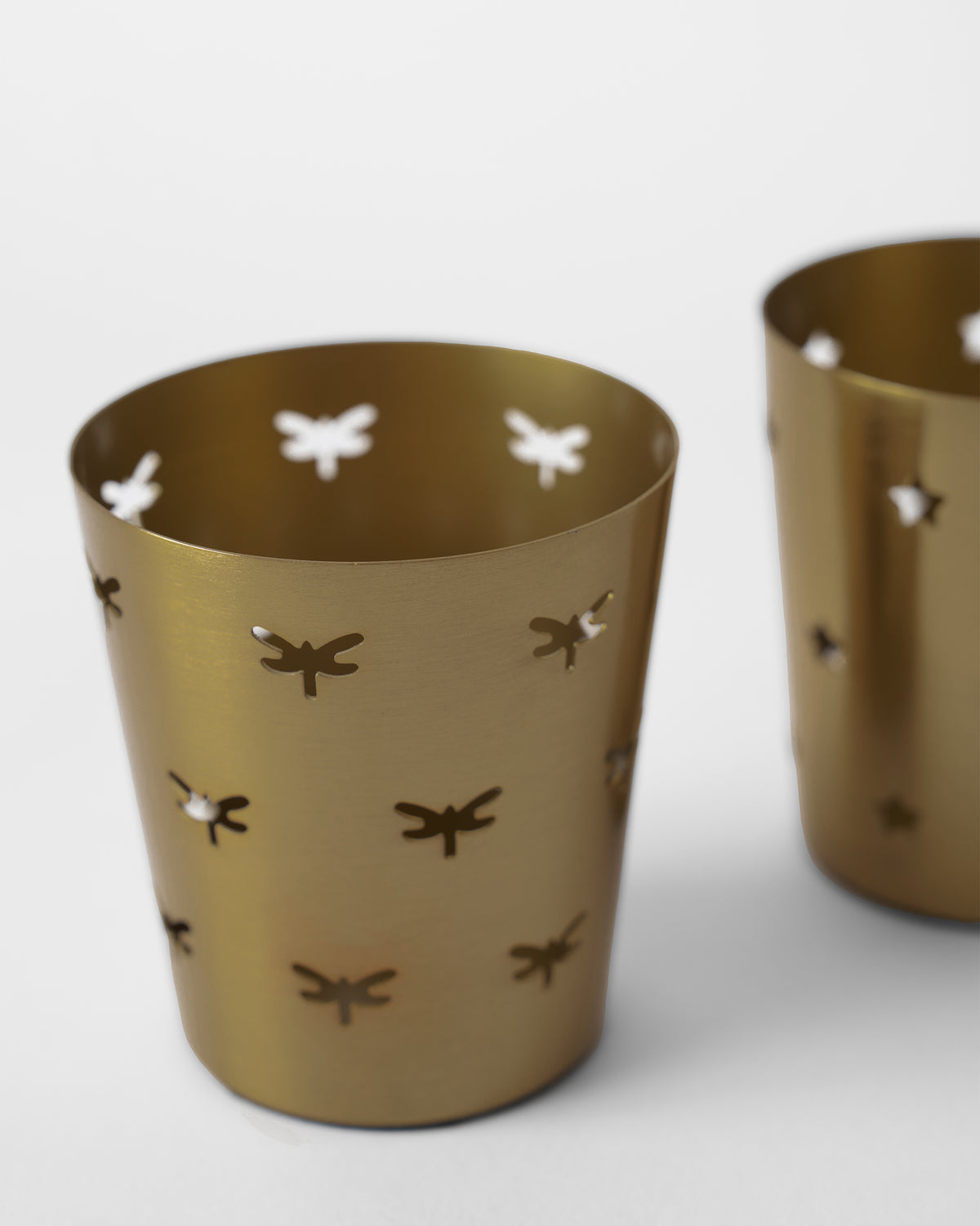 Close-up of Smriti gold votive showing dragonfly-shaped cutouts.