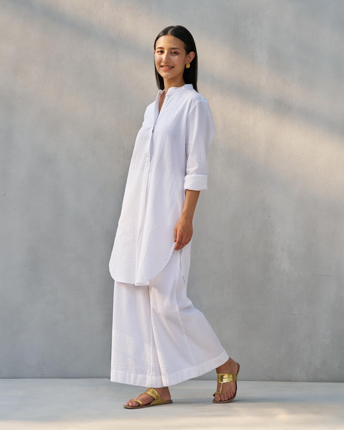 Side view of a white seersucker Ice Set with wide-leg pants.