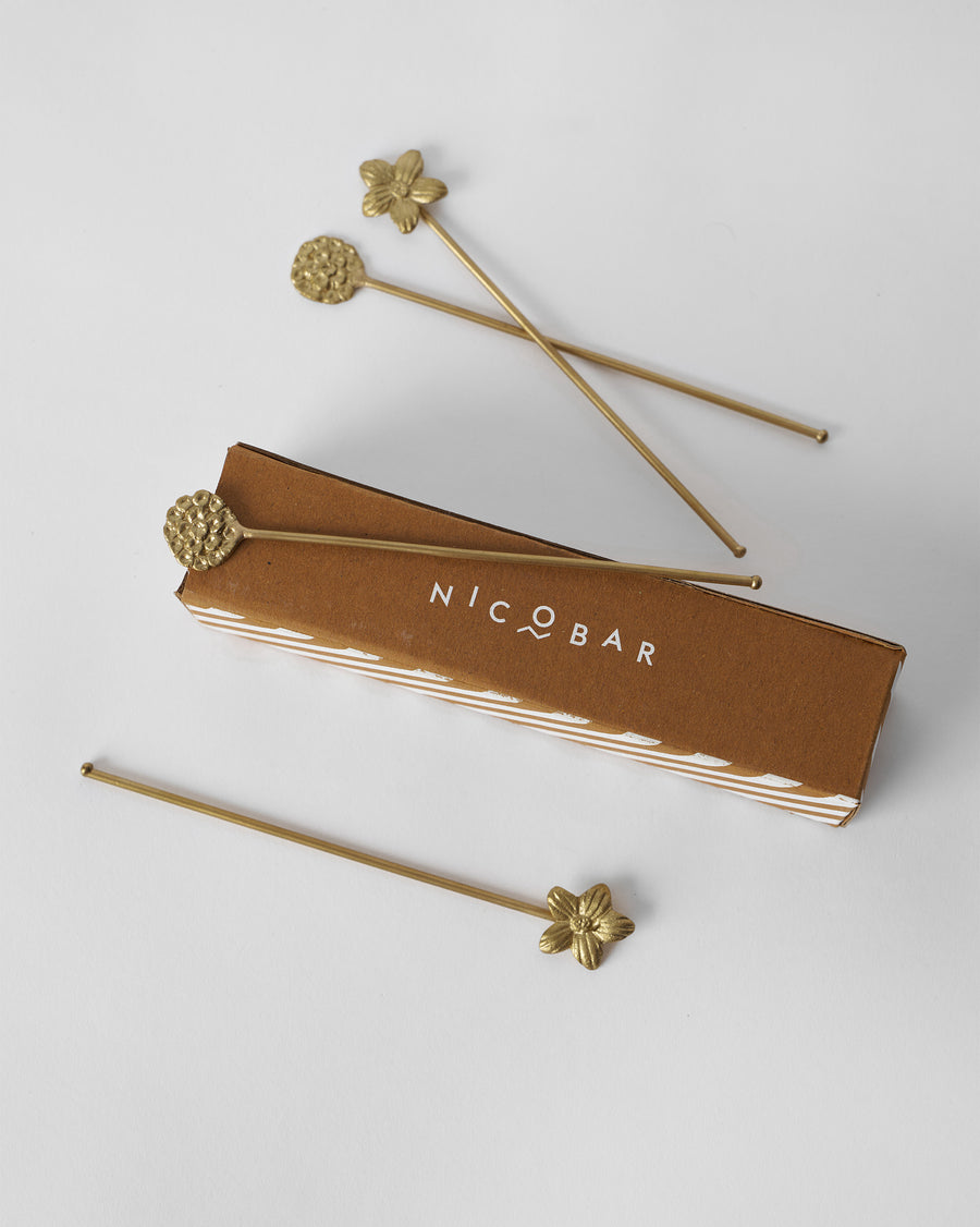 The stirrers on their brown box.
