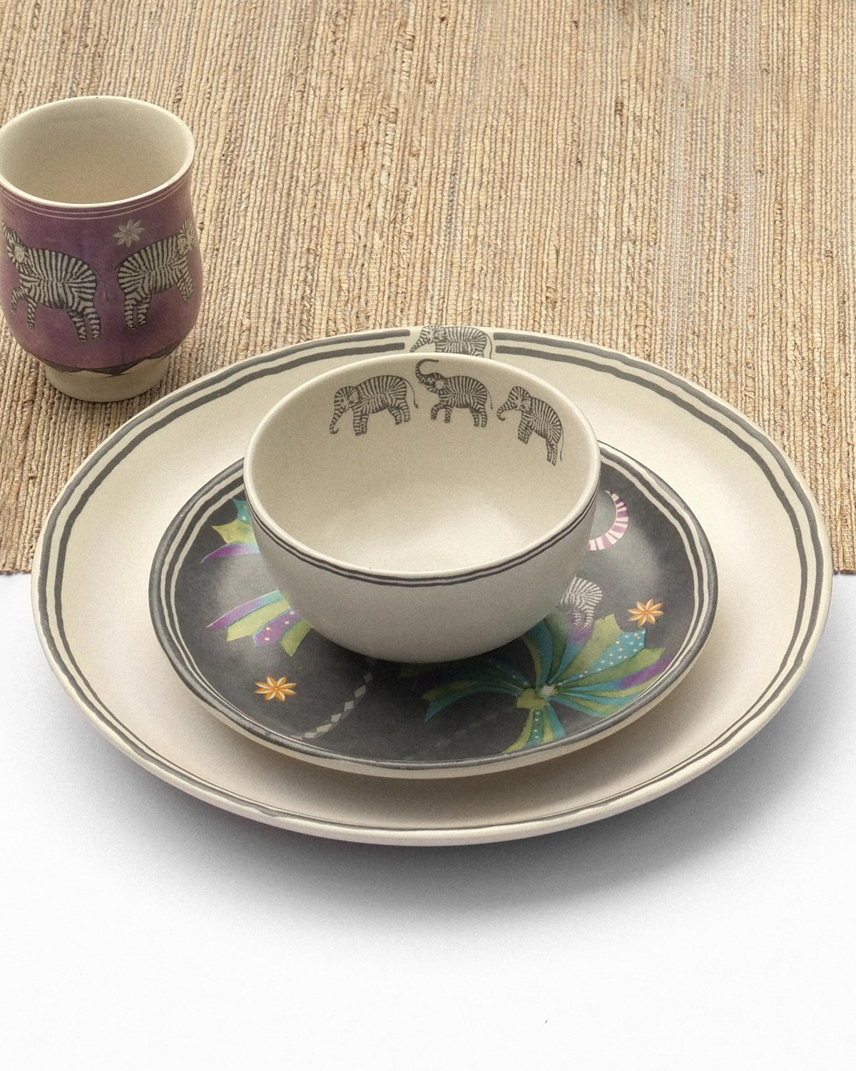 Stacked plates and elephant-motif bowl from the Tusk Dinner Set for 2.