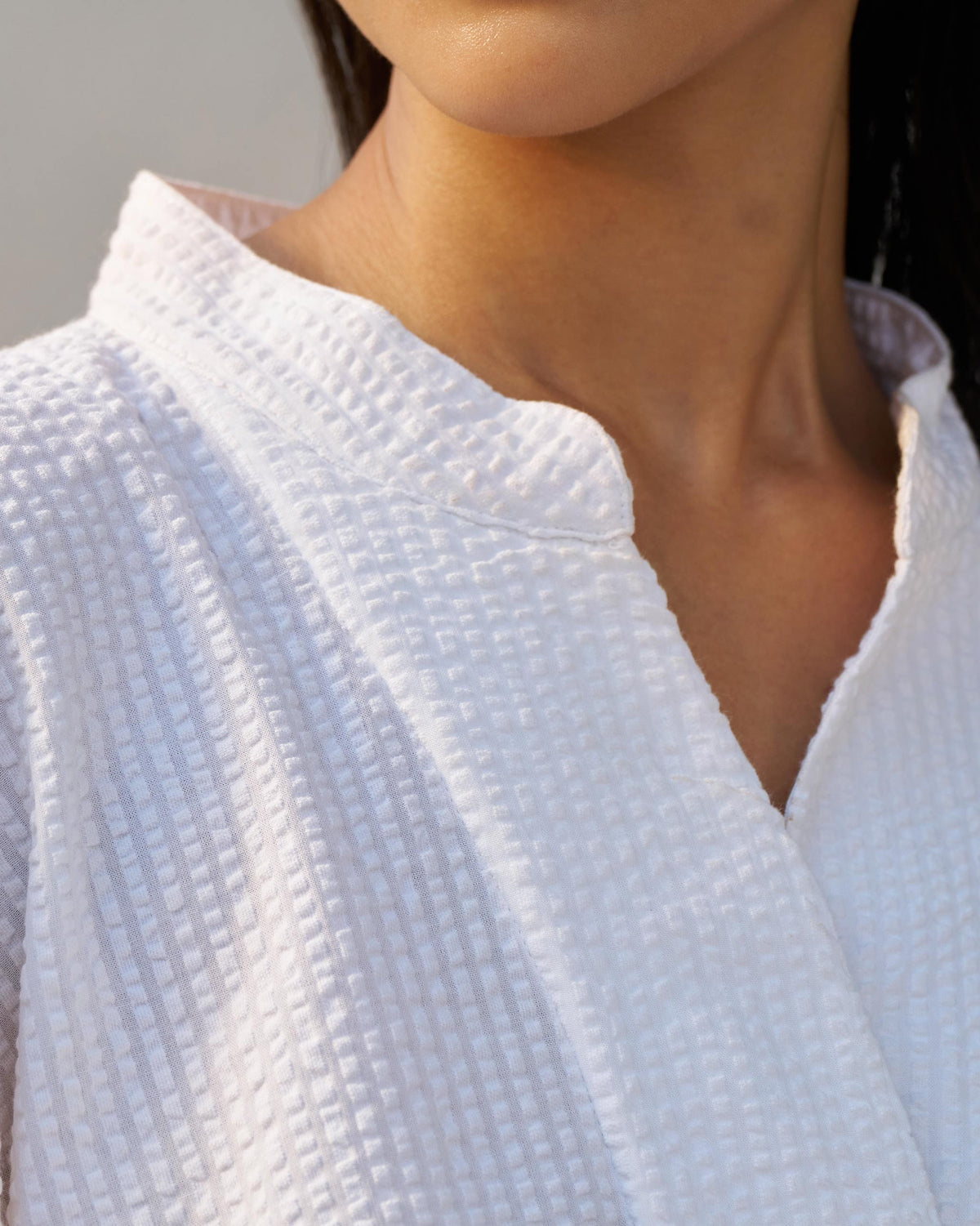 Close-up of the mandarin collar on a white seersucker Cirrus shirt.