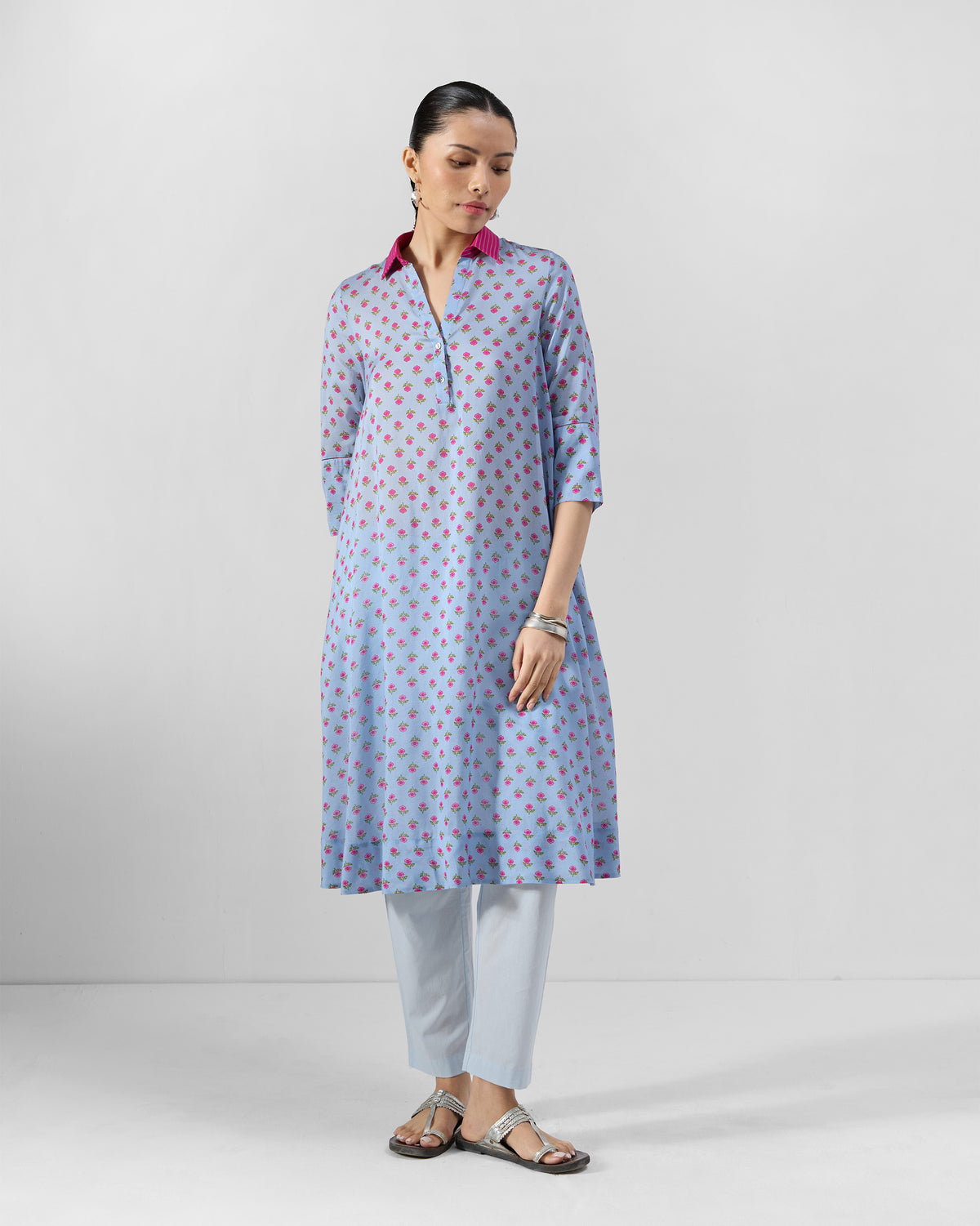 Person wearing an ice blue Kovvur Kurta Set with pink floral print.