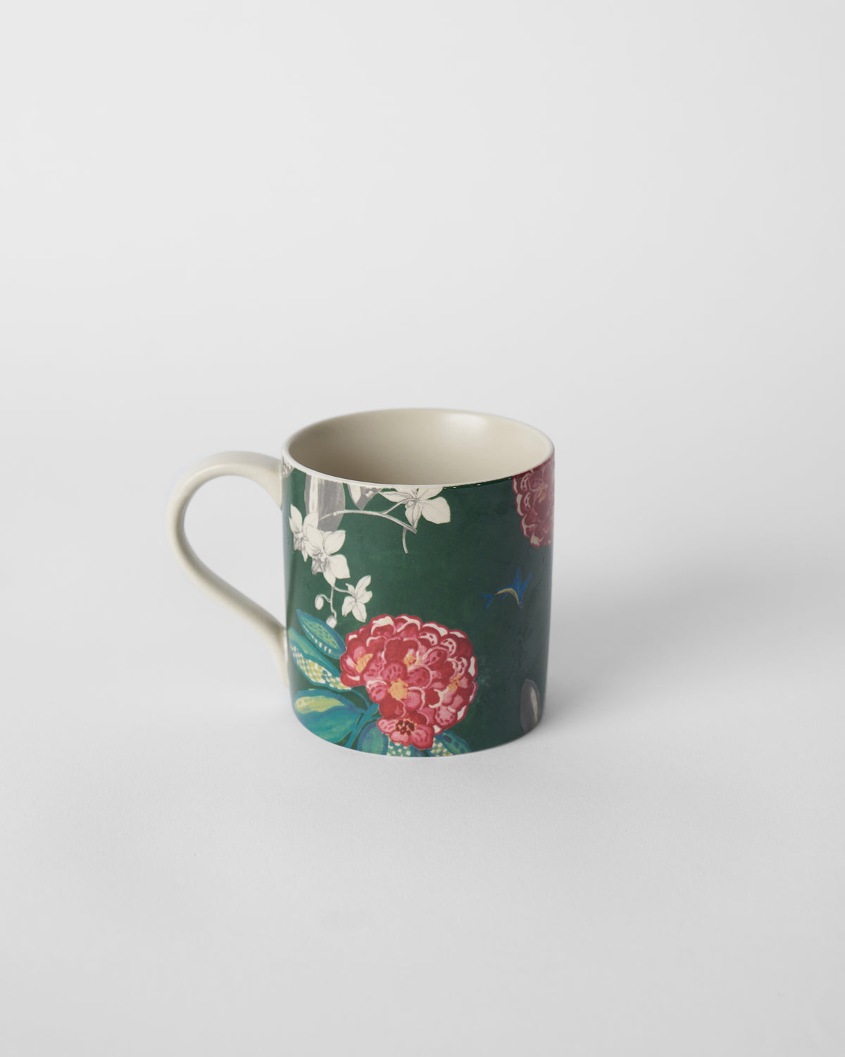 Forest green straight mug with a large red buransh flower and cream handle.