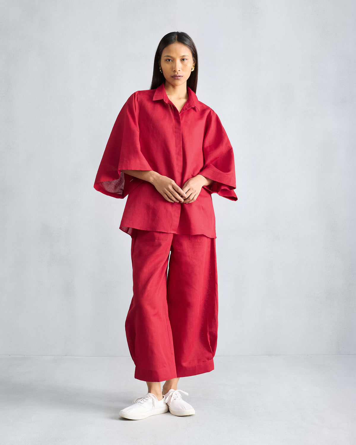 Person wearing the Drop Armhole Shirt Set in red with wide-sleeved shirt and wide-leg trousers.