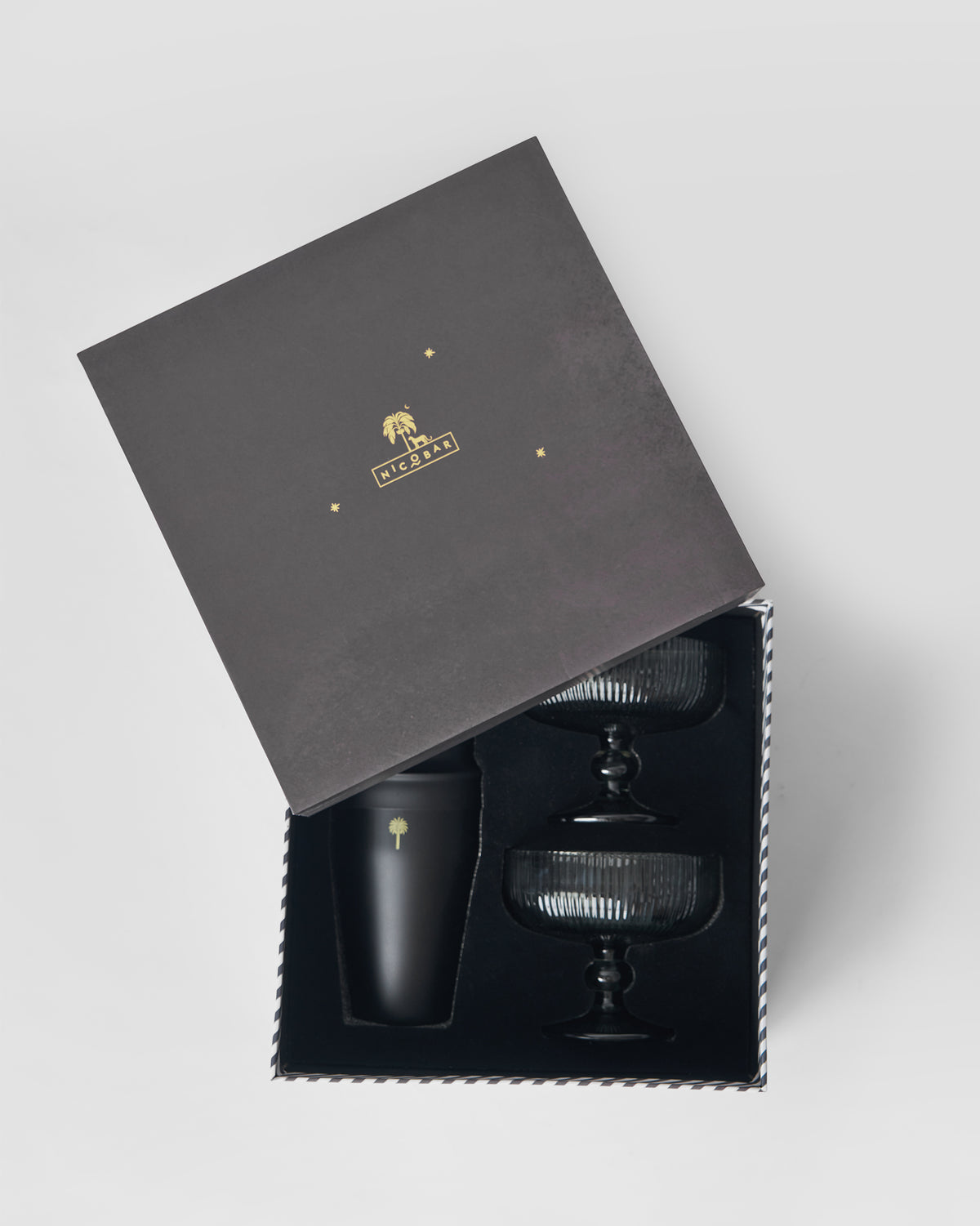 Avi bar set packed in its charcoal gift box with smoked glasses and black shaker.