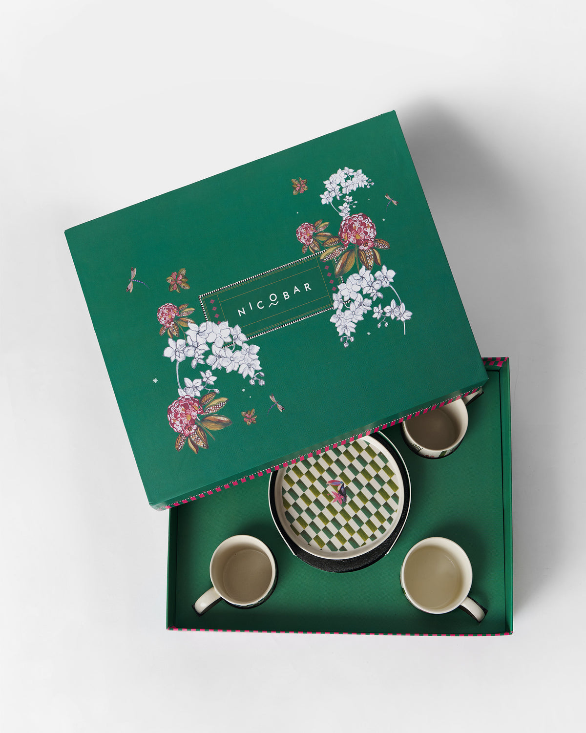 Hornbill gift set nestled in its green floral box with a checkered plate at center.