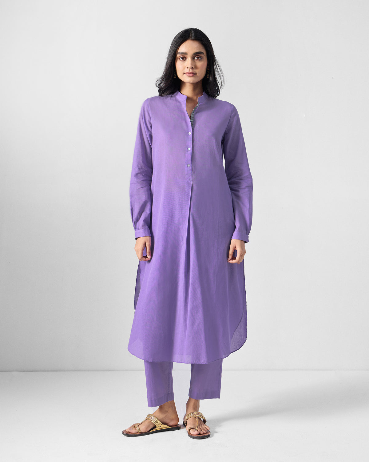 Person wearing a lilac long kurta set with a short button placket.