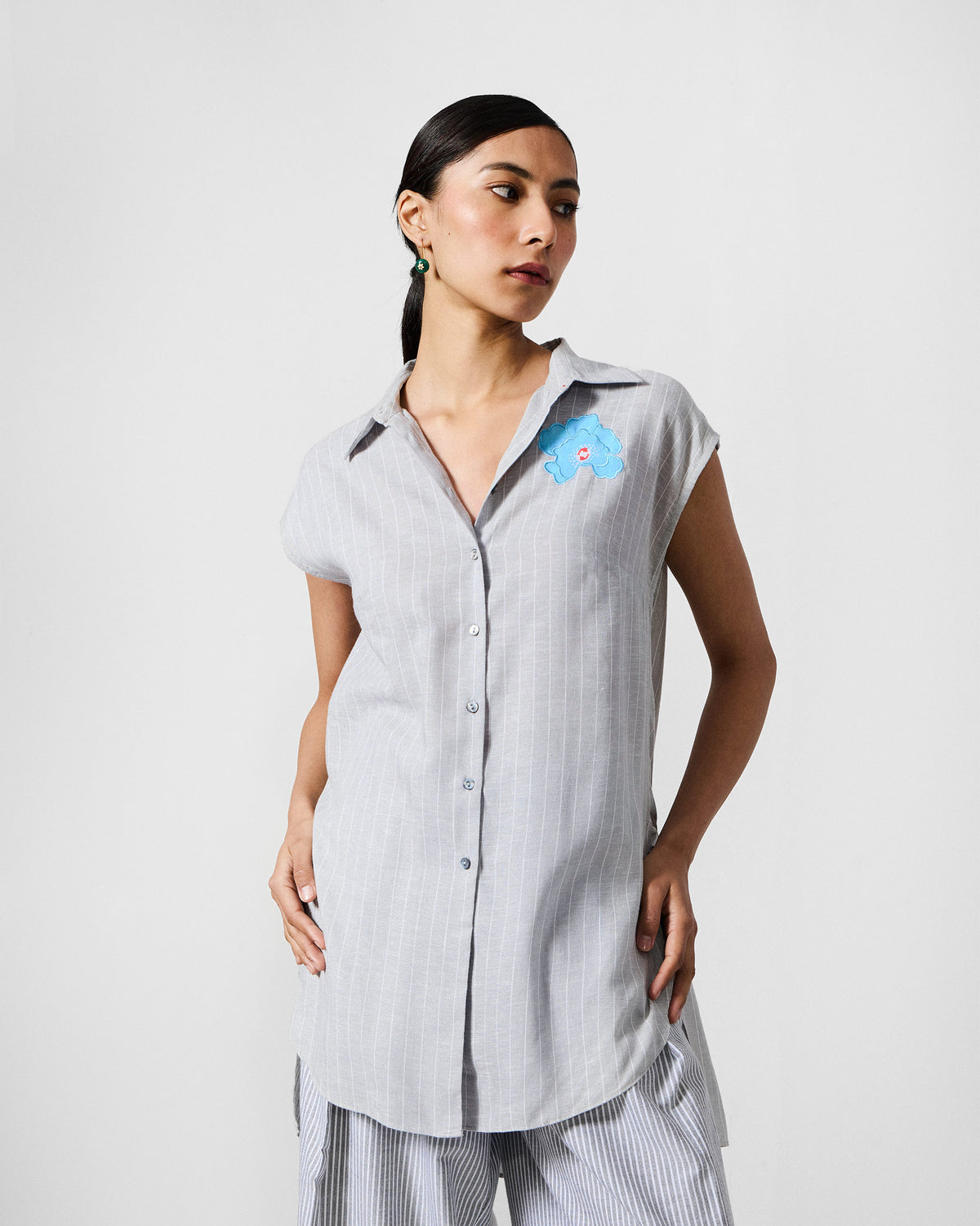 Person wearing a grey and white striped Rin Top Set with side slits.