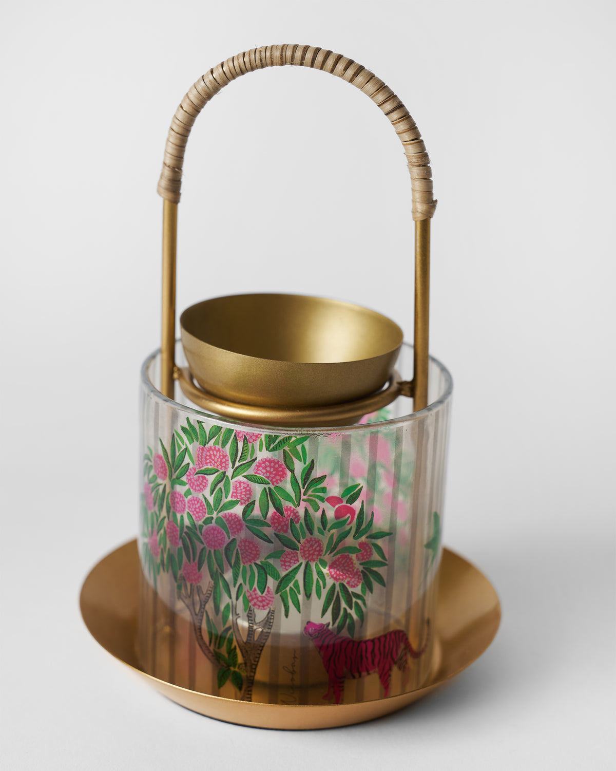 Three-quarter view of gold Kandy diffuser with blossom and tiger glass.