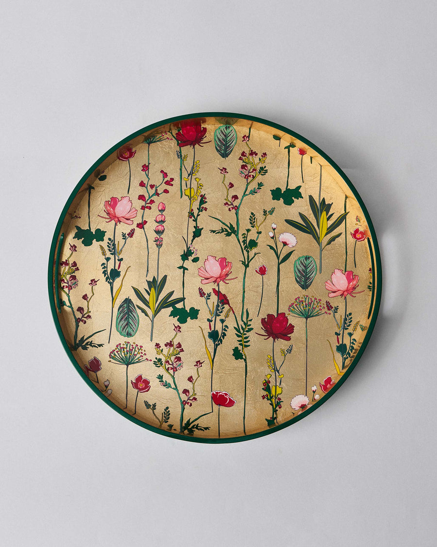The Mahi Round Tray from above, its gold base full of flowers.