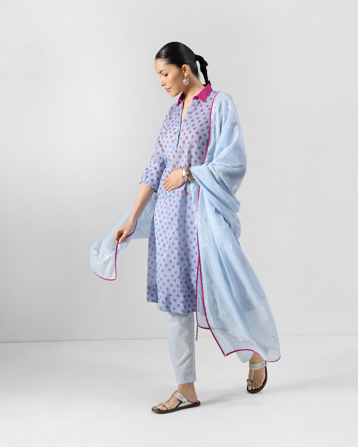 Person wearing an ice blue Kovvur Kurta Set with a sheer pink-piped dupatta.