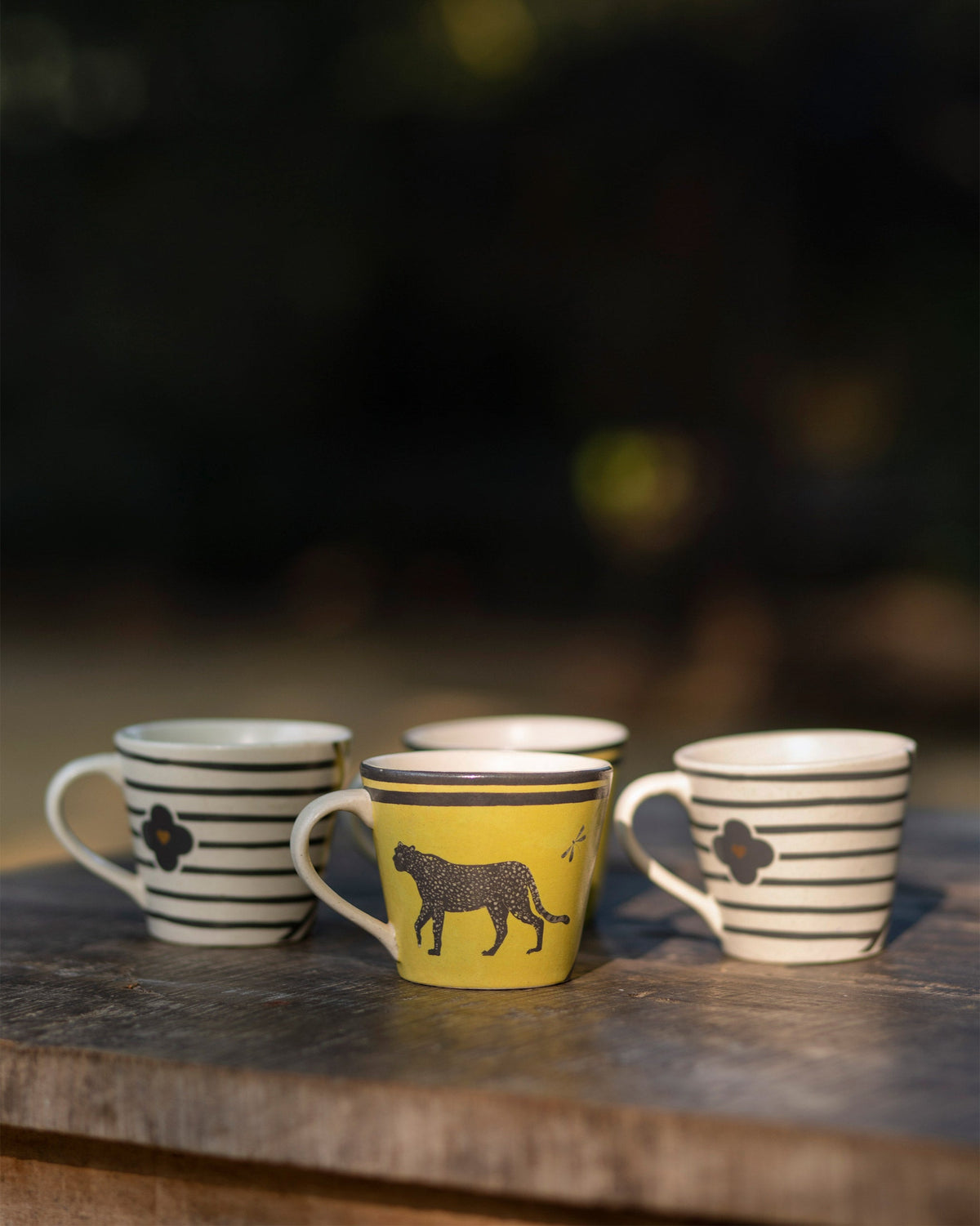Moonlight tea set mugs in yellow leopard and black-striped cream designs.