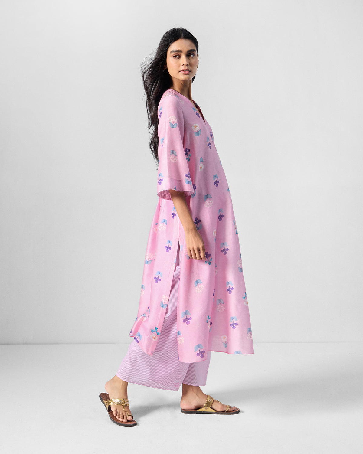 Side view of a pink floral Hera Kurta Set showing the side slit.