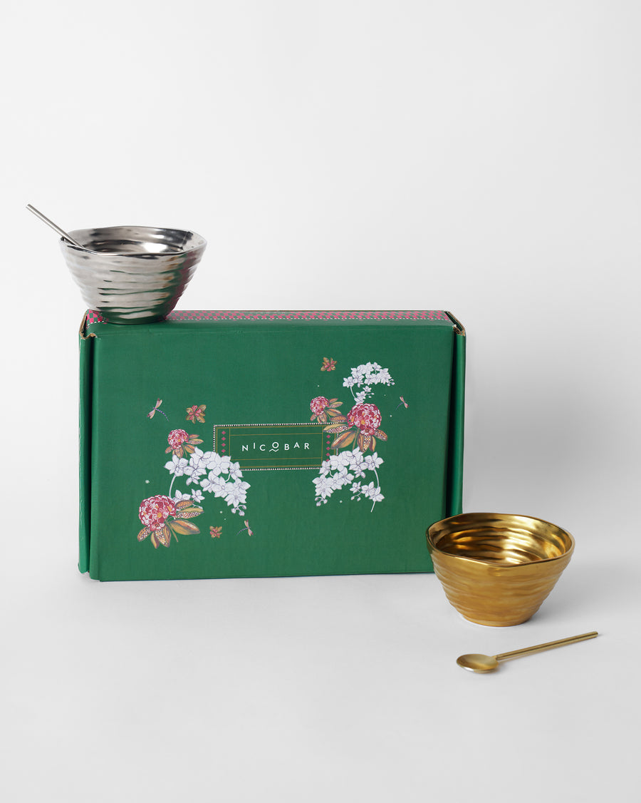 A bowl beside its green gift box.