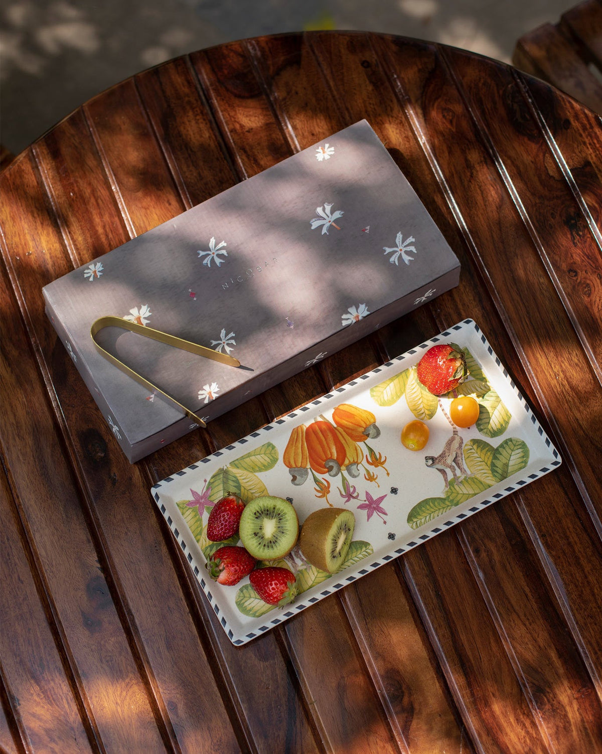 Mahi cookie tray with cashew motifs, brass tongs and Nicobar gift box.