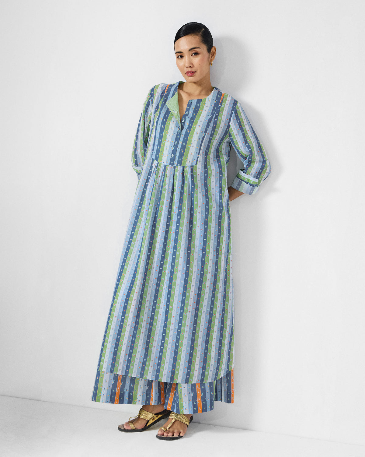 Person wearing the Imke kurta set with cuffed three-quarter sleeves and striped palazzos.
