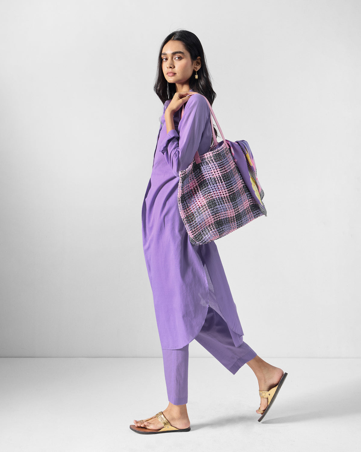Person wearing a lilac long kurta set shown in a walking profile.
