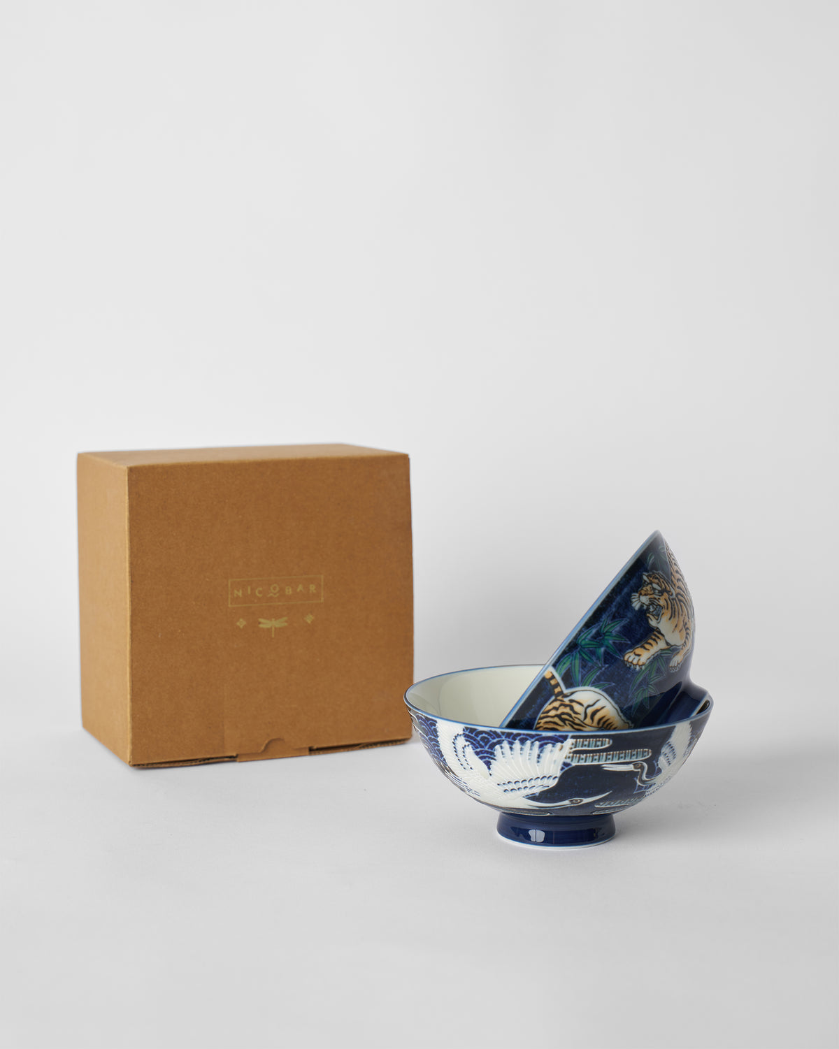 Blue Crane and Tiger Bowl set with a brown Nicobar gift box.