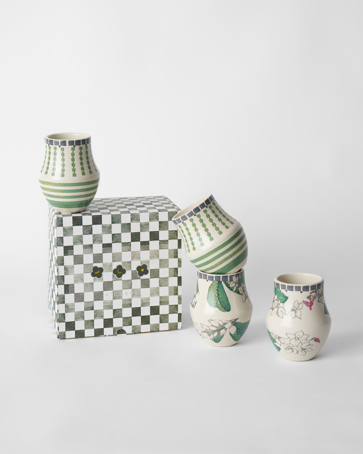 Reesha kulhar set of four with a green checkered Nicobar gift box.