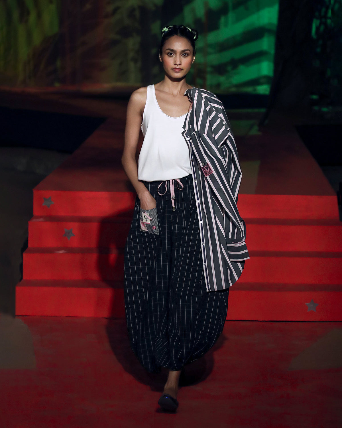 Charcoal and pink striped Trench shirt draped over a shoulder.
