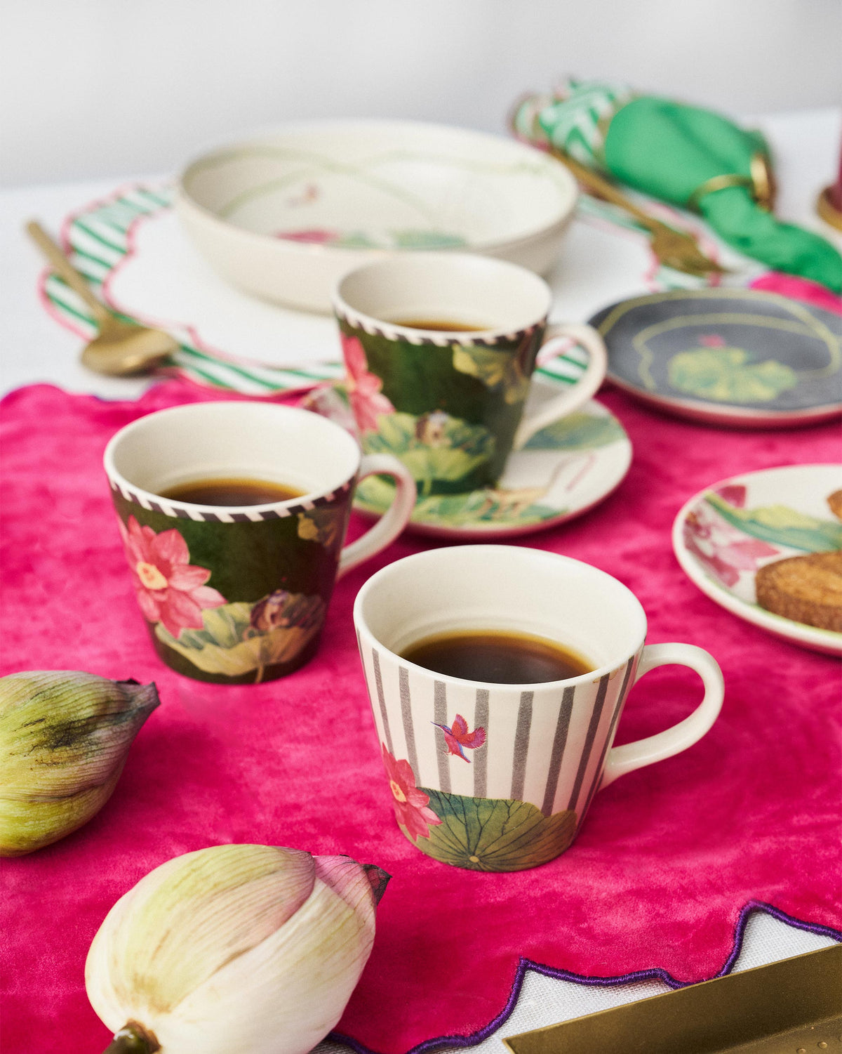 Floating Lotus mugs with lotus prints, set out on a table.