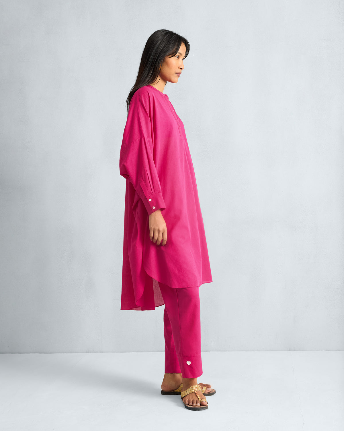 Side view of a fuchsia Lazy Sunday Tunic Set showing the high-low hem.