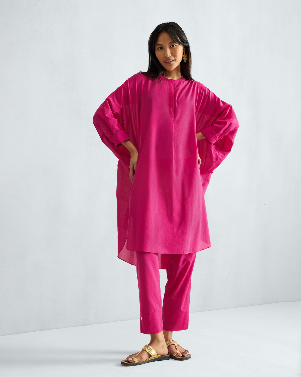 Person wearing a fuchsia Lazy Sunday Tunic Set with wide batwing sleeves.