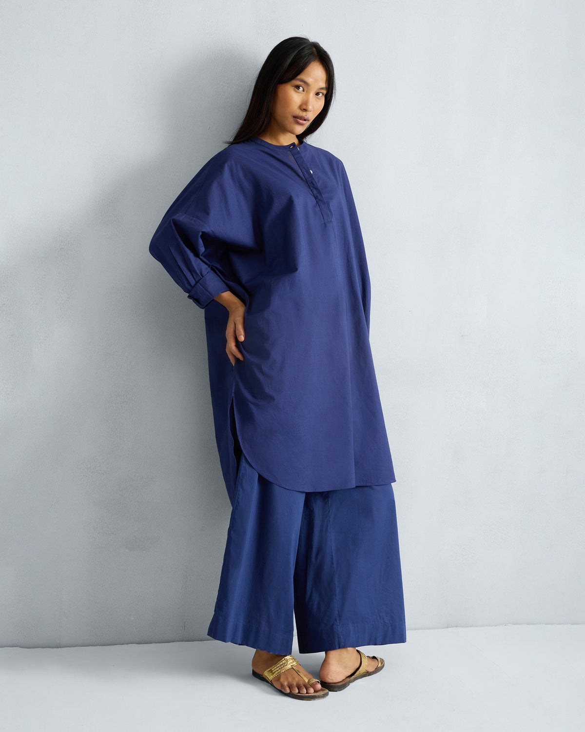 Person wearing the Lazy Sunday Tunic Set in ink blue with a band collar and wide sleeves.