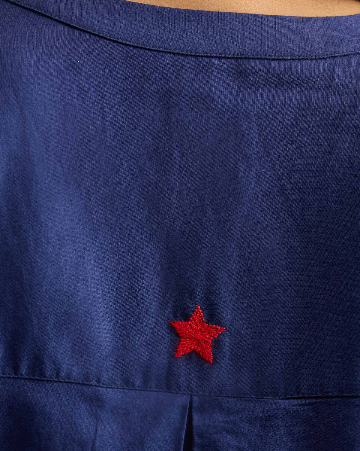 Close-up of the Lazy Sunday tunic's back yoke showing a red embroidered star.
