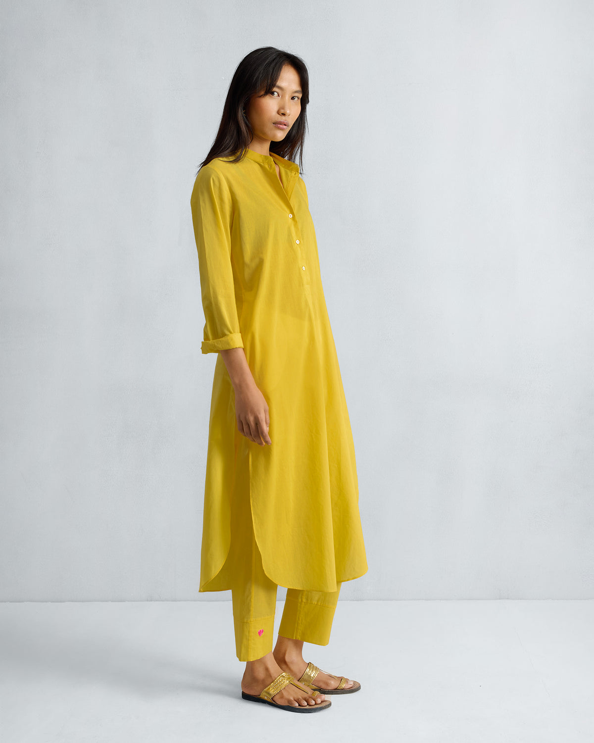 Side view of a yellow long kurta set showing the side slit and length.