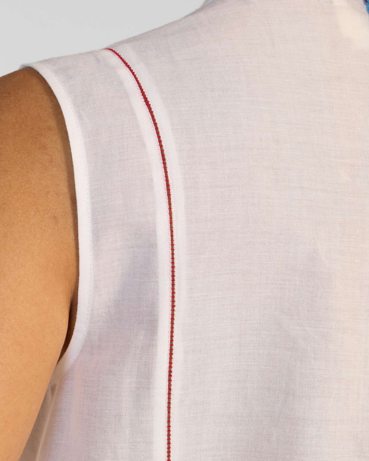 Close-up of red contrast stitching along the armhole of a white Riha kurta.