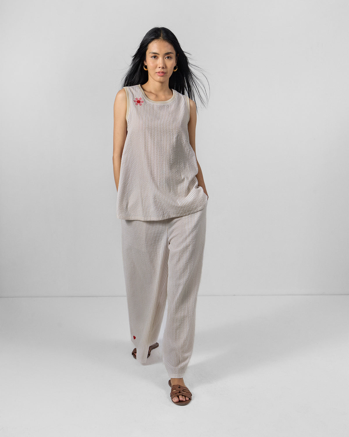 Person wearing a brown and ivory Tavira top set with wide-leg pants.