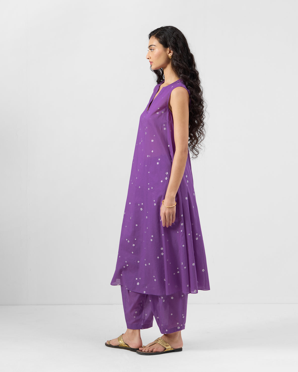 Side view of a purple floral kurta with matching pants.
