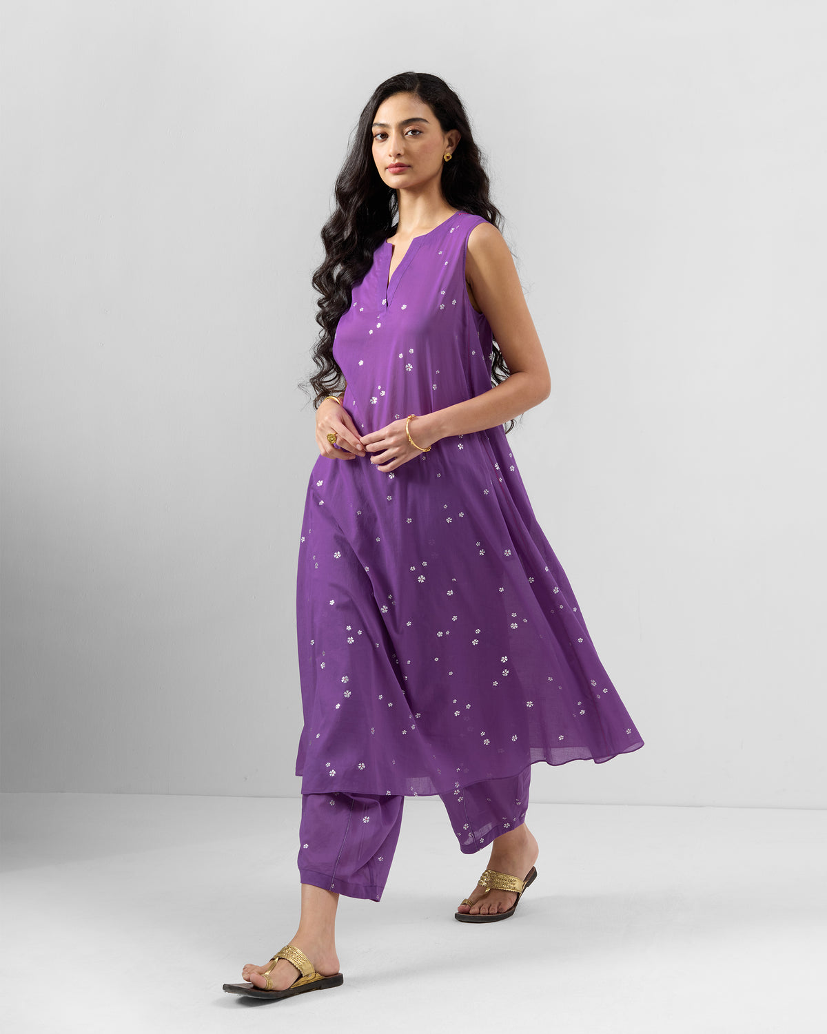 Person wearing a purple floral kurta set with a V-neckline.