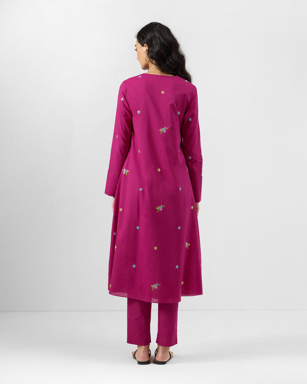 Back of a magenta Narsa Kurta Set with floral embroidery.
