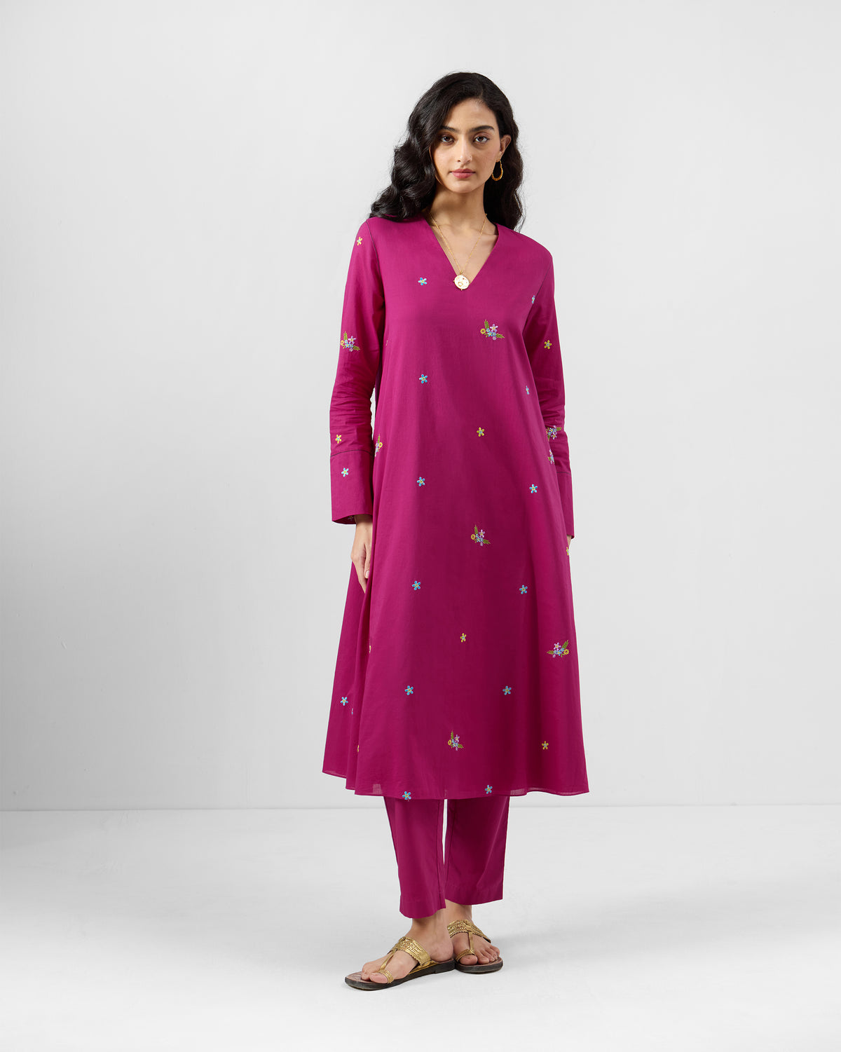 Person wearing a magenta Narsa Kurta Set with a V-neck and matching pants.