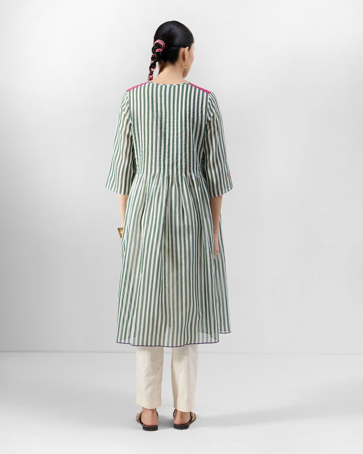 Back of a green striped kurta with pink shoulder panels.