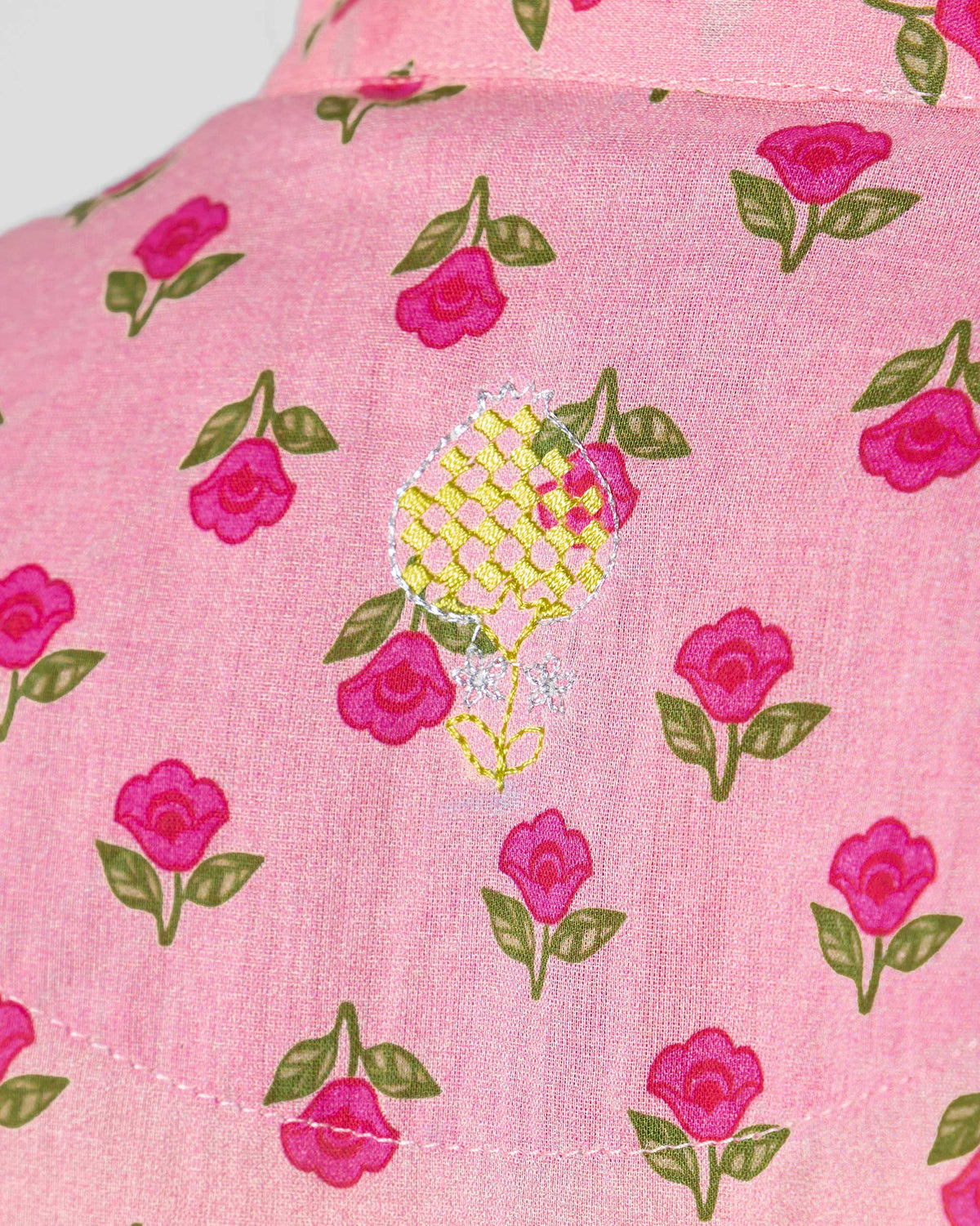 Close-up of a yellow pineapple embroidery on a pink Summer Fun kurta.