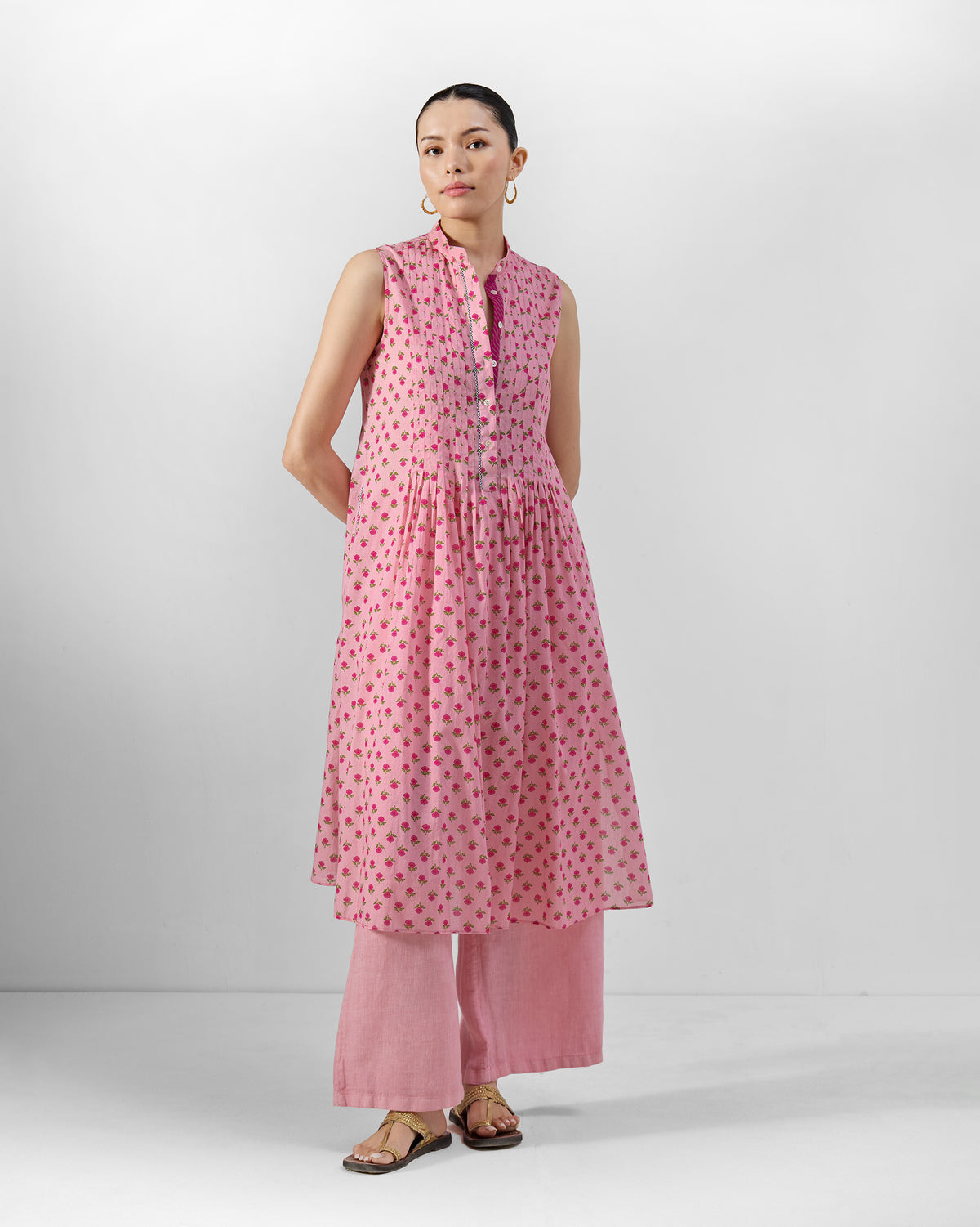Person wearing a pink floral Summer Fun kurta set with a gathered flare.