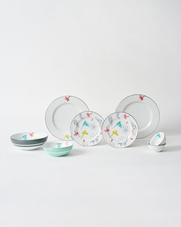 Botanical Dinner set with plates and bowls laid out on white.